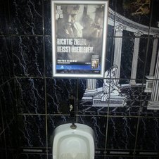 Dieses Werbeposter ist in der Herrentoilette gut platziert